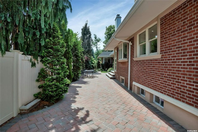 view of side of property with a patio