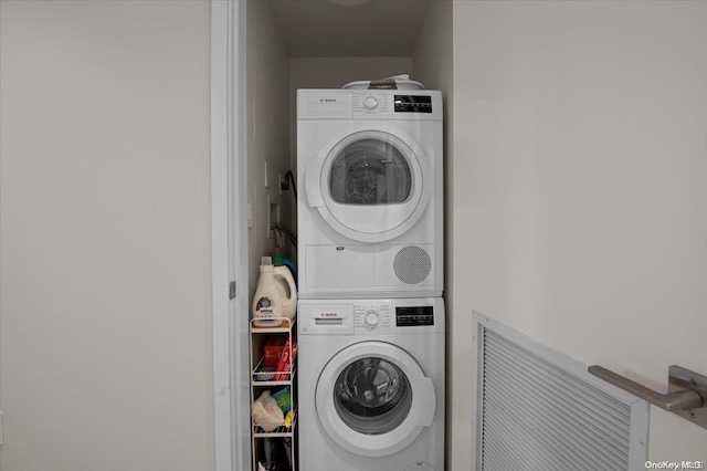 laundry room featuring stacked washer / drying machine