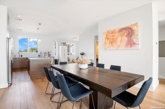 dining room featuring light hardwood / wood-style flooring and sink