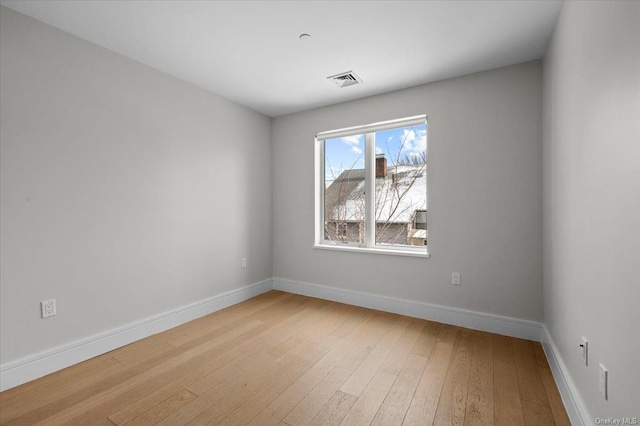 spare room with light wood-type flooring