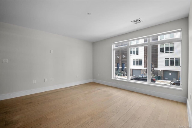 unfurnished room with light hardwood / wood-style floors