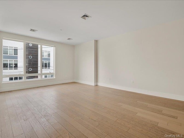 unfurnished room with light wood-type flooring