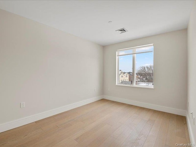 spare room with light hardwood / wood-style flooring