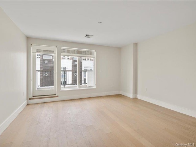 spare room with light hardwood / wood-style flooring