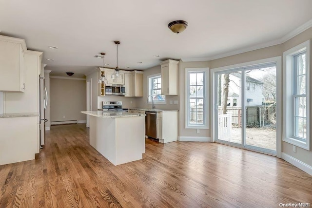 kitchen featuring a center island, hanging light fixtures, light hardwood / wood-style flooring, appliances with stainless steel finishes, and a baseboard radiator