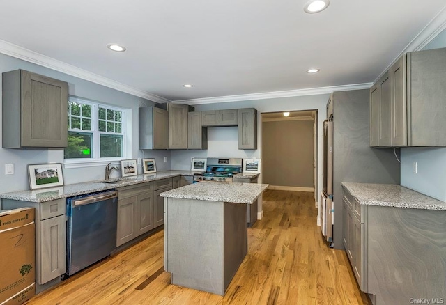 kitchen with crown molding, appliances with stainless steel finishes, gray cabinets, a kitchen island, and light hardwood / wood-style floors