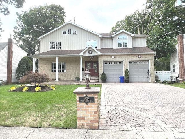 view of front of home featuring a front yard and a garage