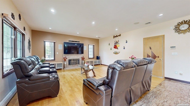 living room featuring light hardwood / wood-style floors and a fireplace