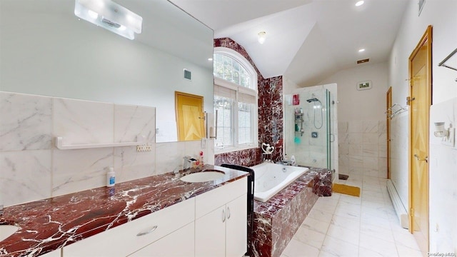 bathroom with separate shower and tub, vanity, and lofted ceiling