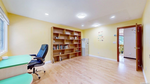 office area with plenty of natural light and light wood-type flooring