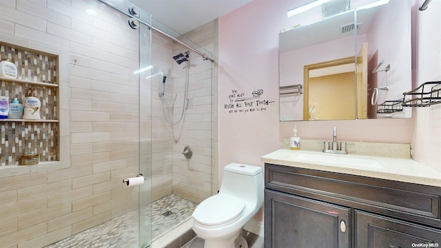 bathroom featuring walk in shower, vanity, and toilet