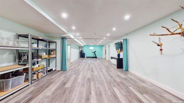 corridor with light hardwood / wood-style flooring