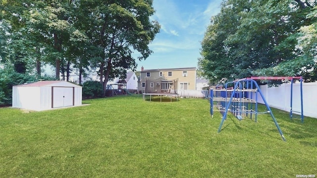 view of yard featuring a playground, a storage shed, and a trampoline