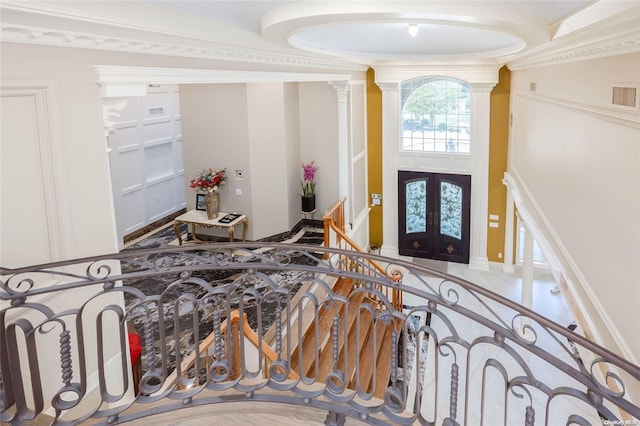 entryway featuring ornate columns and french doors