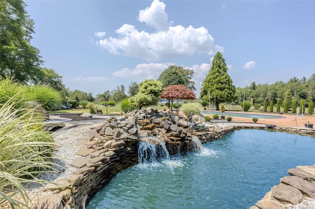 view of pool with pool water feature