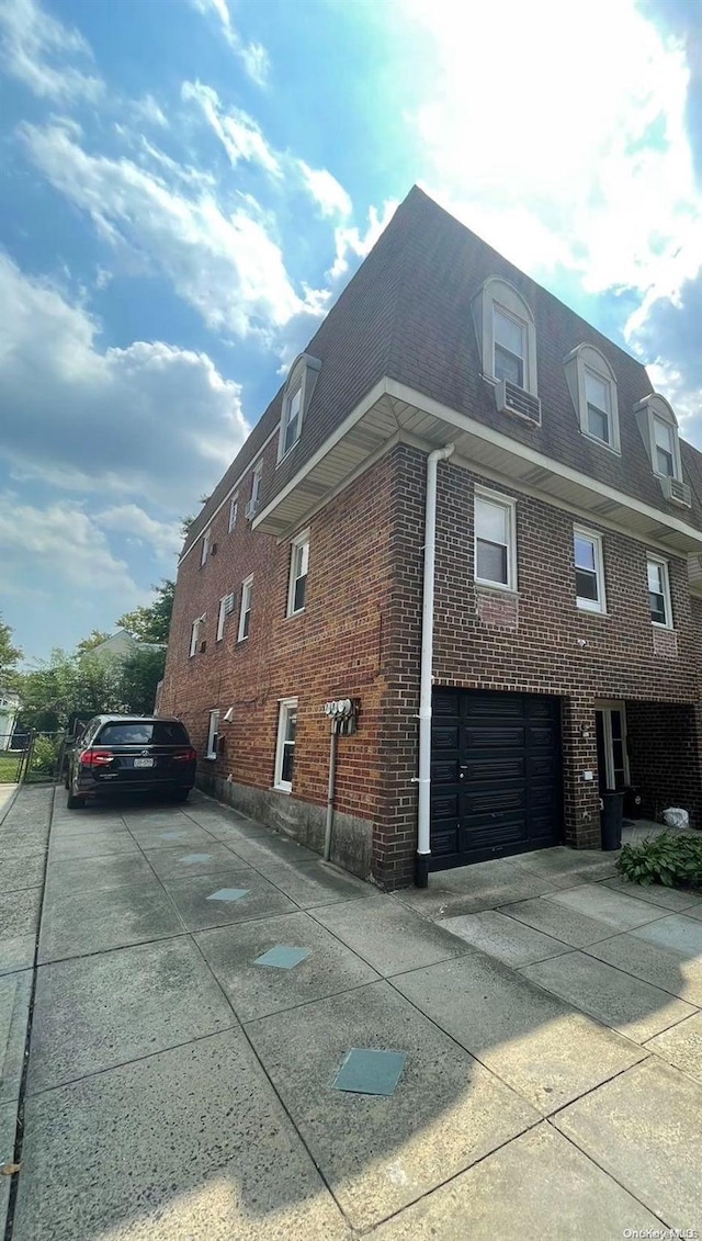 view of side of home featuring a garage