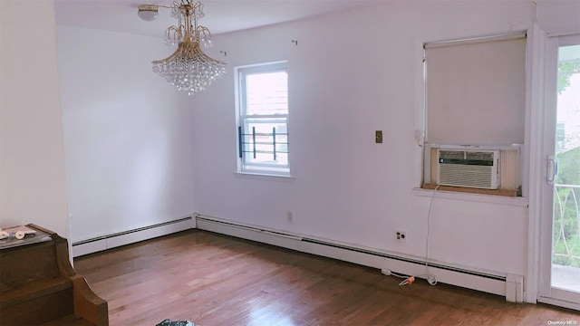 unfurnished room with baseboard heating, cooling unit, a notable chandelier, and hardwood / wood-style flooring