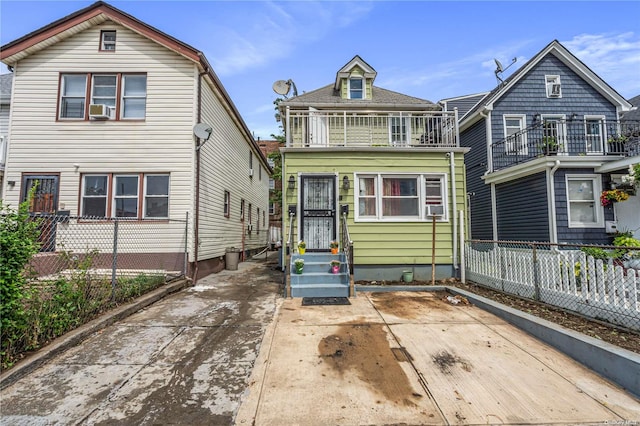 front of property with a balcony and cooling unit