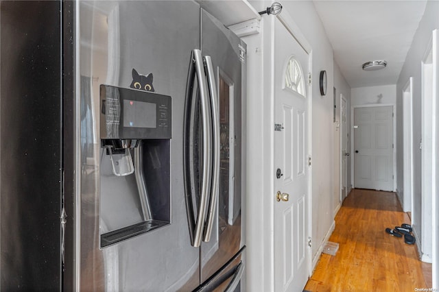 kitchen featuring stainless steel fridge and hardwood / wood-style flooring