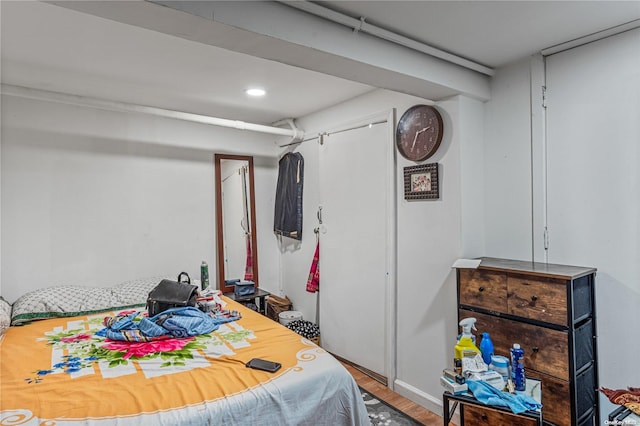 bedroom with hardwood / wood-style flooring