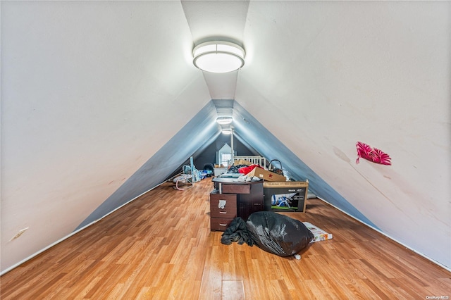 home office with light hardwood / wood-style floors and vaulted ceiling