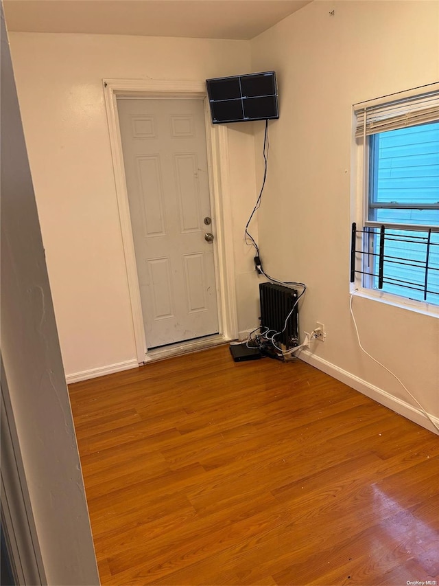 unfurnished room with hardwood / wood-style floors