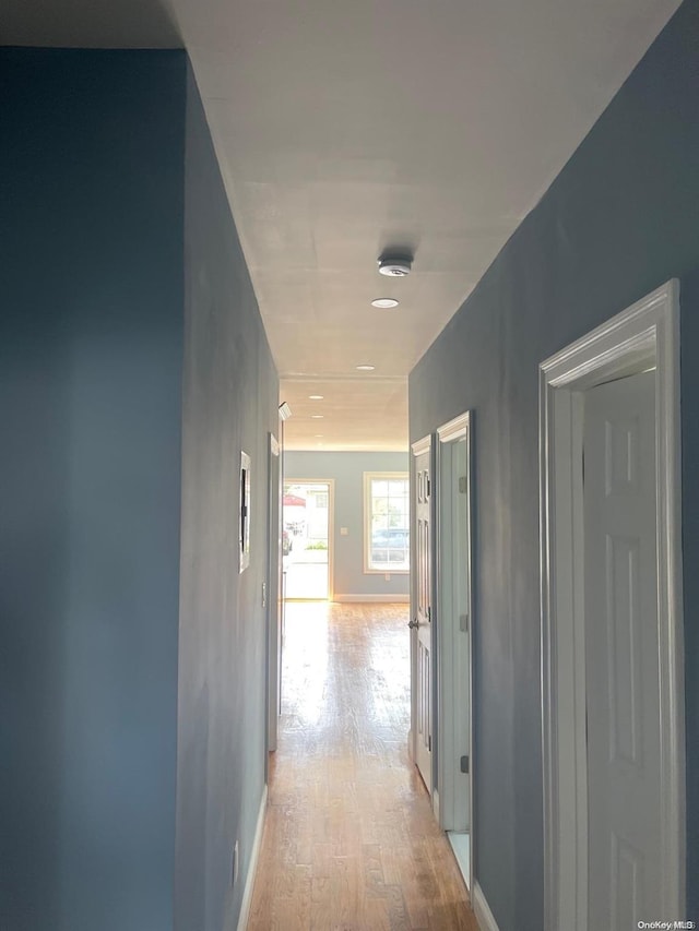 corridor with light hardwood / wood-style floors