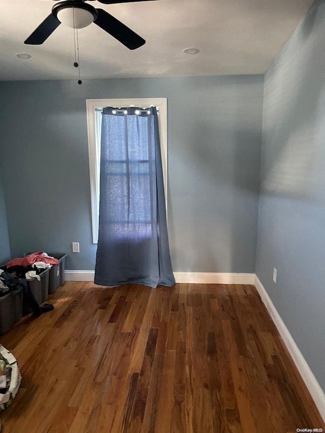 unfurnished room featuring dark hardwood / wood-style floors and ceiling fan