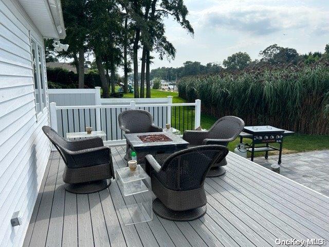 wooden terrace with an outdoor fire pit