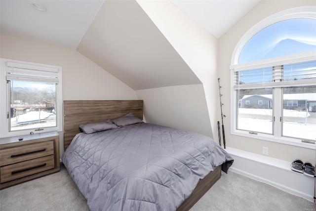 bedroom featuring lofted ceiling and light carpet