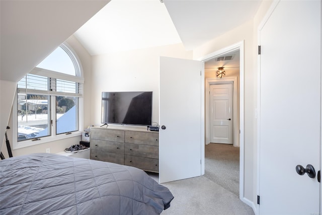 carpeted bedroom featuring lofted ceiling