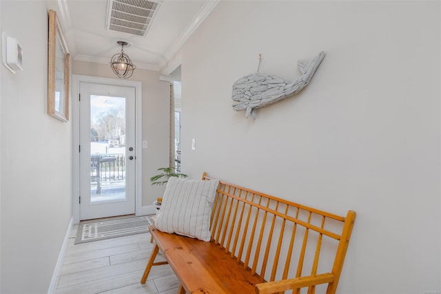 entryway featuring ornamental molding and light wood-type flooring