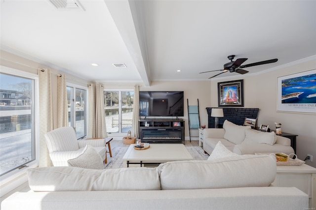 living room with ornamental molding, light wood-type flooring, ceiling fan, and beam ceiling