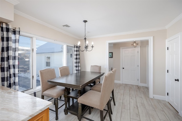 dining space featuring ornamental molding, plenty of natural light, a chandelier, and light wood-type flooring