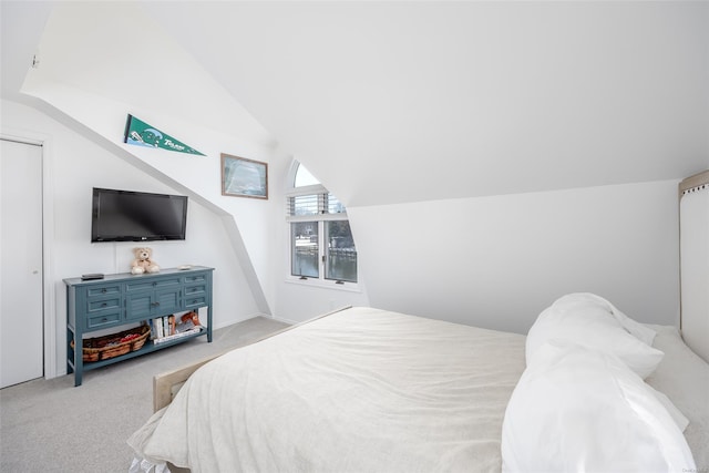 carpeted bedroom with lofted ceiling