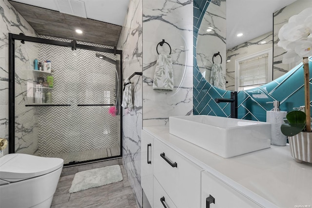 bathroom with vanity, toilet, an enclosed shower, and tile walls