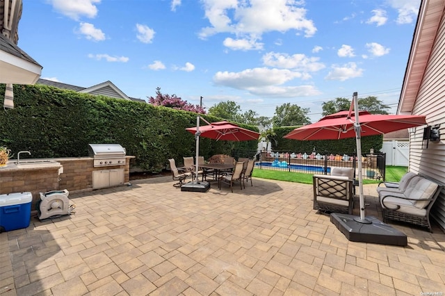 view of patio / terrace with area for grilling, outdoor lounge area, sink, and a pool