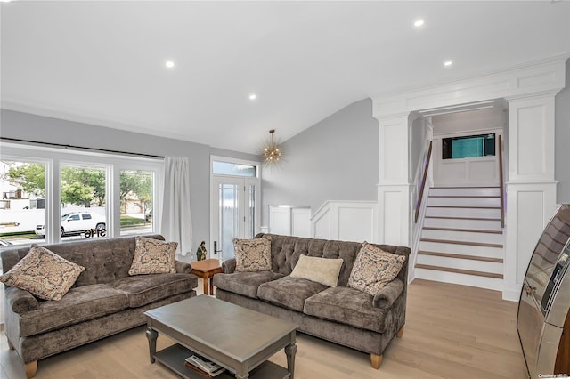 living room with light hardwood / wood-style flooring and vaulted ceiling