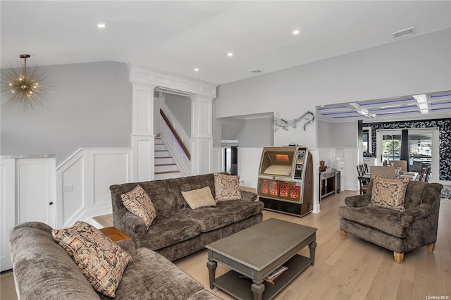 living room featuring ornate columns and light hardwood / wood-style floors