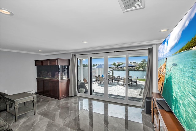 living room with a water view and crown molding