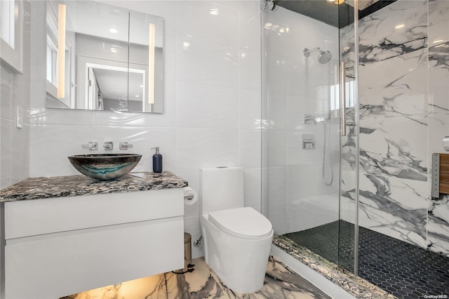 bathroom with backsplash, an enclosed shower, toilet, vanity, and tile walls