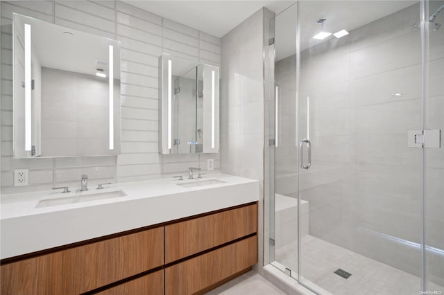 218 Middle Neck Rd Unit 107, Great Neck, NY 11021 - bathroom featuring double vanity, a shower stall, and tile walls
