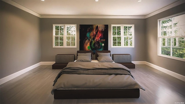 bedroom featuring hardwood / wood-style flooring, multiple windows, and ornamental molding