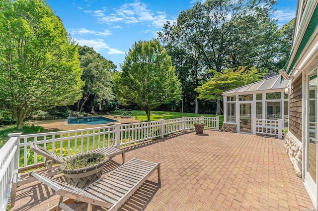 view of patio with a sunroom