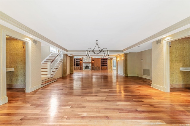 unfurnished living room with hardwood / wood-style flooring and ornamental molding