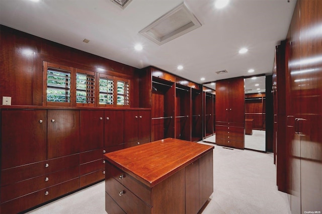 spacious closet featuring light carpet