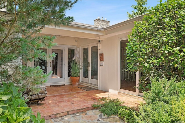 view of exterior entry with french doors and a patio