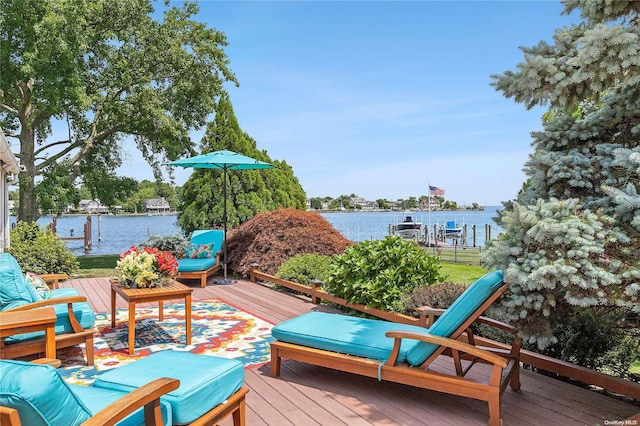 wooden terrace featuring a water view