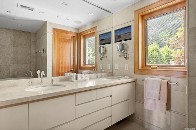 bathroom with vanity and tile walls