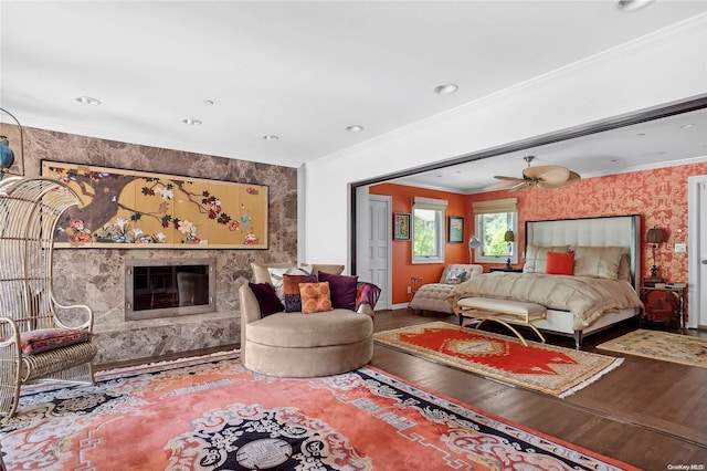 bedroom with a fireplace, hardwood / wood-style flooring, and ornamental molding